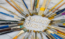 The words Paint Night surrounded by paint brushes